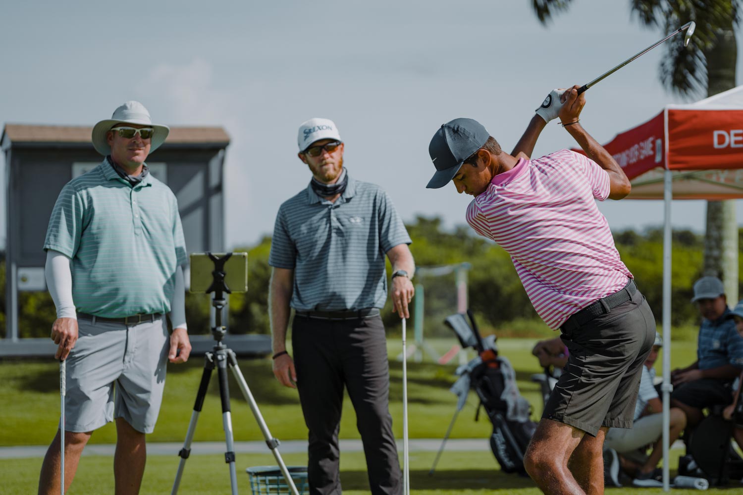 A man swinging at a golf ball on the course