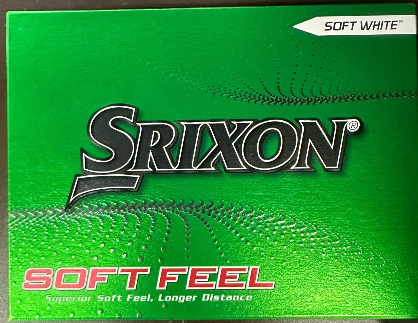 A box of golf balls that are green and white.