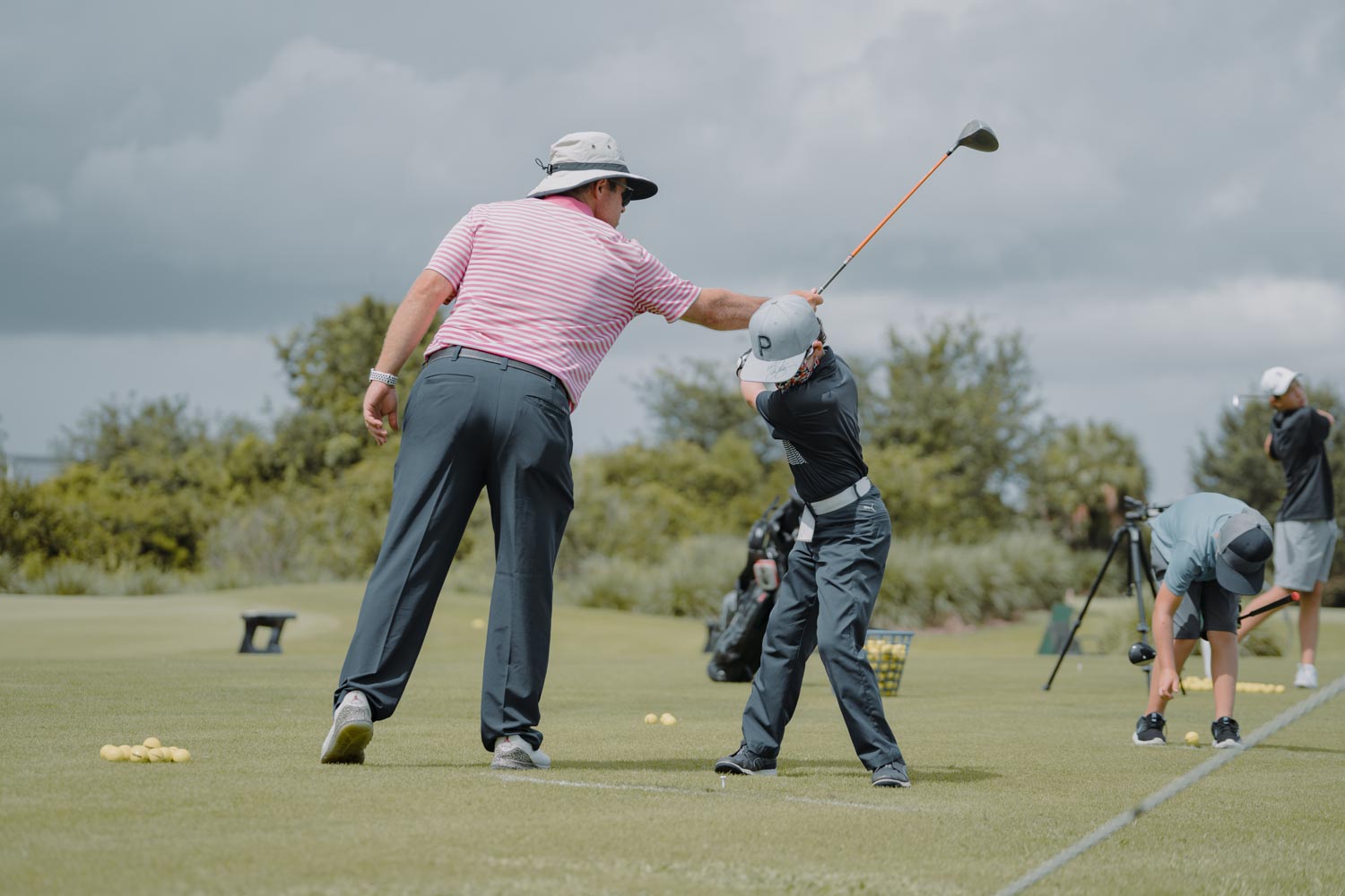 A man and boy playing golf on the green.